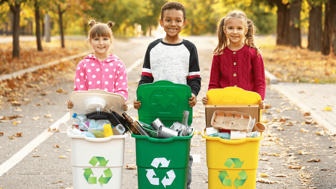 three kids with three recycle bins