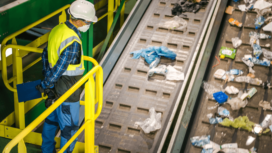 Worker overlooking trash sorting